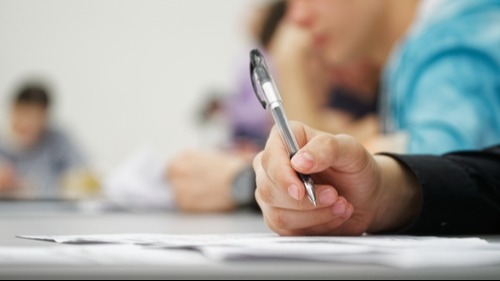 Hand holding a pen