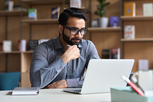 man studying with laptop